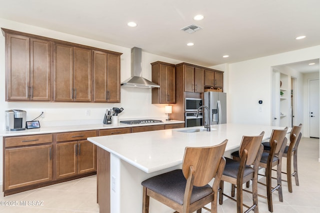 7823 W Buckeye Path, Marana, AZ 85658 - kitchen featuring wall chimney exhaust hood, a sink, appliances with stainless steel finishes, an island with sink, and recessed lighting