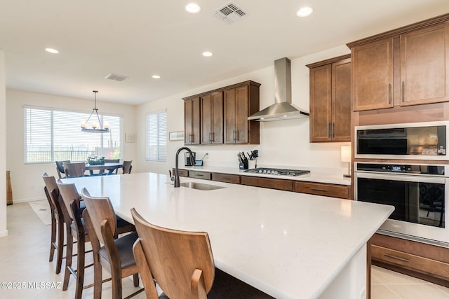 7823 W Buckeye Path, Marana, AZ 85658 - kitchen with appliances with stainless steel finishes, a sink, wall chimney exhaust hood, recessed lighting, and a chandelier