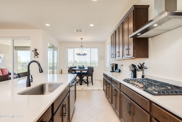 7823 W Buckeye Path, Marana, AZ 85658 - kitchen with wall chimney exhaust hood, appliances with stainless steel finishes, a sink, light countertops, and recessed lighting