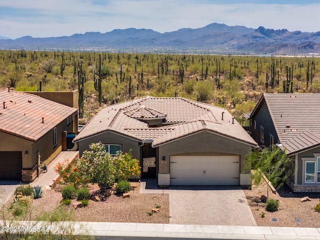 7823 W Buckeye Path, Marana, AZ 85658 - view of front facade with a mountain view, an attached garage, stucco siding, and a tiled roof