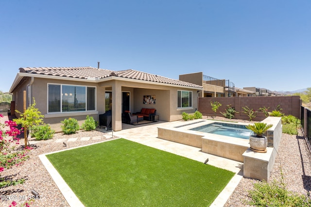 7823 W Buckeye Path, Marana, AZ 85658 - back of property with an in-ground hot tub, a patio area, a tiled roof, and stucco siding