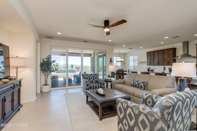 7823 W Buckeye Path, Marana, AZ 85658 - living area featuring a ceiling fan, light tile patterned flooring, recessed lighting, baseboards, and a chandelier