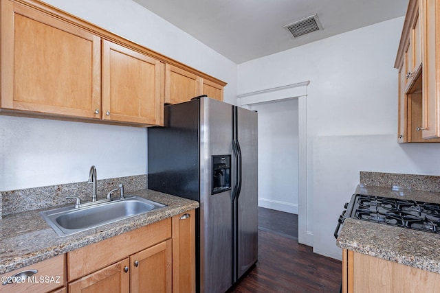 1034 N 7th Ave, Tucson, AZ 85705 - kitchen featuring a sink, dark wood-type flooring, stainless steel refrigerator with ice dispenser, baseboards, and light brown cabinetry