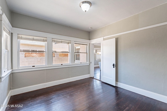 1034 N 7th Ave, Tucson, AZ 85705 - unfurnished room featuring hardwood / wood-style floors, baseboards, and a textured wall