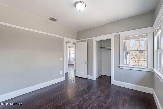 1034 N 7th Ave, Tucson, AZ 85705 - unfurnished bedroom featuring hardwood / wood-style flooring, baseboards, and a closet