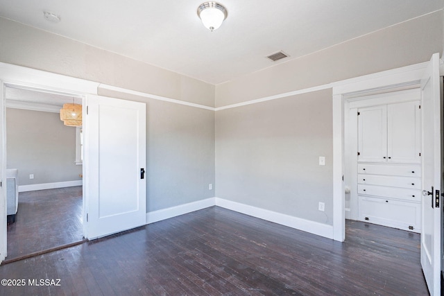 1034 N 7th Ave, Tucson, AZ 85705 - spare room with dark wood-style flooring, baseboards, and a smoke detector