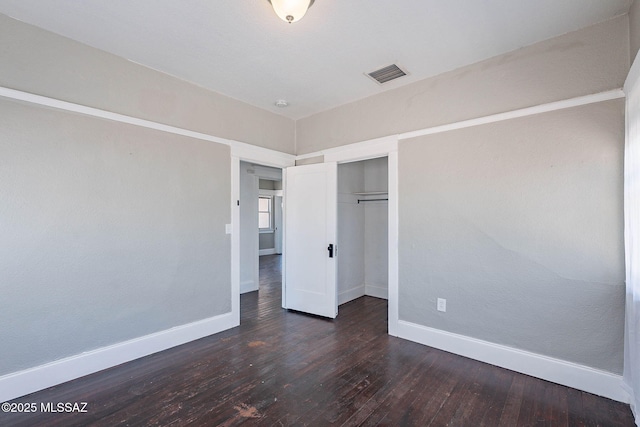 1034 N 7th Ave, Tucson, AZ 85705 - unfurnished bedroom featuring baseboards, hardwood / wood-style flooring, and a closet