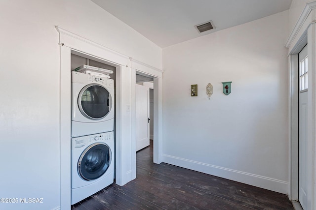 1034 N 7th Ave, Tucson, AZ 85705 - washroom featuring estacked washer and dryer, dark wood-style floors, and baseboards