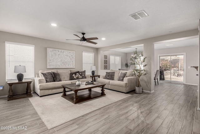 1257 W Calle Libro Del Retrato, Sahuarita, AZ 85629 - living room with light wood-style flooring, baseboards, a ceiling fan, and recessed lighting