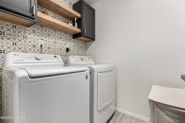 1257 W Calle Libro Del Retrato, Sahuarita, AZ 85629 - laundry room featuring cabinet space, washing machine and dryer, baseboards, and light wood-type flooring
