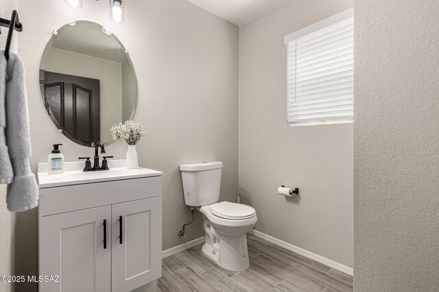 1257 W Calle Libro Del Retrato, Sahuarita, AZ 85629 - half bathroom featuring toilet, vanity, baseboards, and wood tiled floors