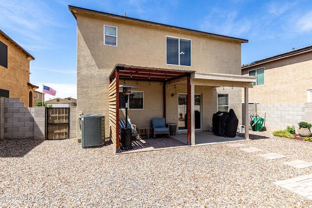 1257 W Calle Libro Del Retrato, Sahuarita, AZ 85629 - rear view of house with central AC, stucco siding, a gate, and a patio area