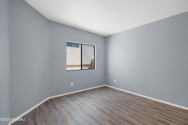4996 N Valle Rd, Tucson, AZ 85750 - unfurnished room with wood finished floors and baseboards