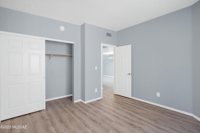 4996 N Valle Rd, Tucson, AZ 85750 - unfurnished bedroom with wood finished floors, a closet, and baseboards