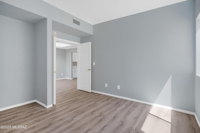 4996 N Valle Rd, Tucson, AZ 85750 - unfurnished room featuring wood finished floors and baseboards
