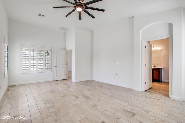 9016 W Birchover Dr, Marana, AZ 85653 - spare room with ceiling fan, light wood-type flooring, baseboards, and a towering ceiling