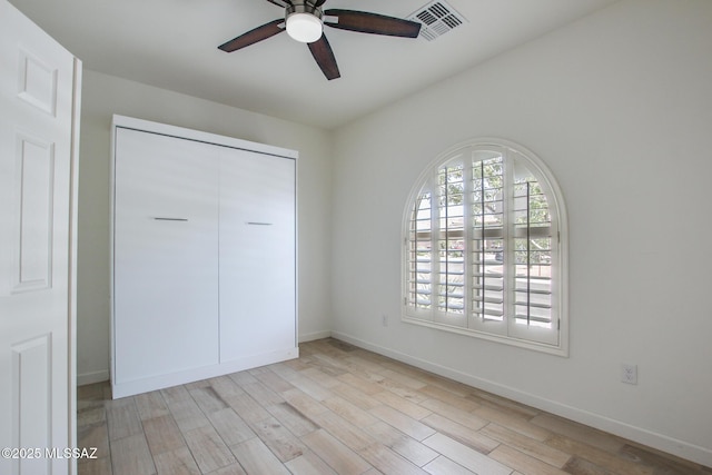 9016 W Birchover Dr, Marana, AZ 85653 - unfurnished bedroom featuring light wood-style floors, baseboards, a closet, and ceiling fan