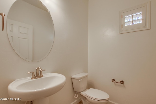 9016 W Birchover Dr, Marana, AZ 85653 - half bathroom with a sink, baseboards, and toilet