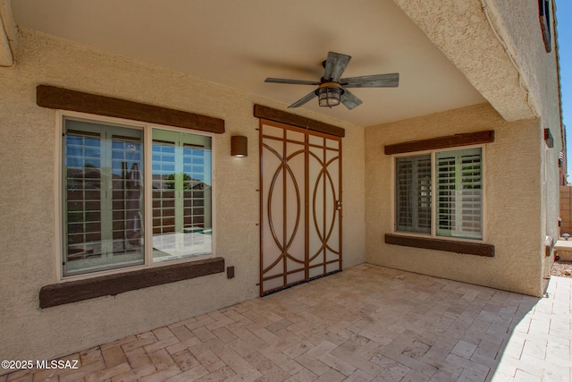 9016 W Birchover Dr, Marana, AZ 85653 - entrance to property featuring a ceiling fan, stucco siding, and a patio