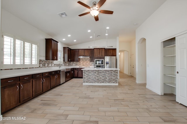 9016 W Birchover Dr, Marana, AZ 85653 - kitchen with stainless steel appliances, arched walkways, ceiling fan, backsplash, and recessed lighting