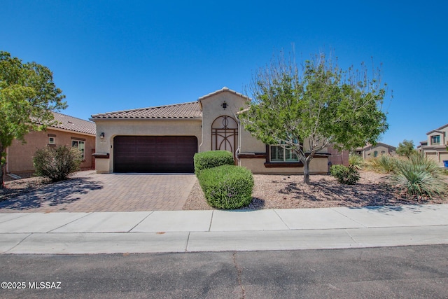 9016 W Birchover Dr, Marana, AZ 85653 - mediterranean / spanish-style house with a garage, decorative driveway, stucco siding, and a tiled roof