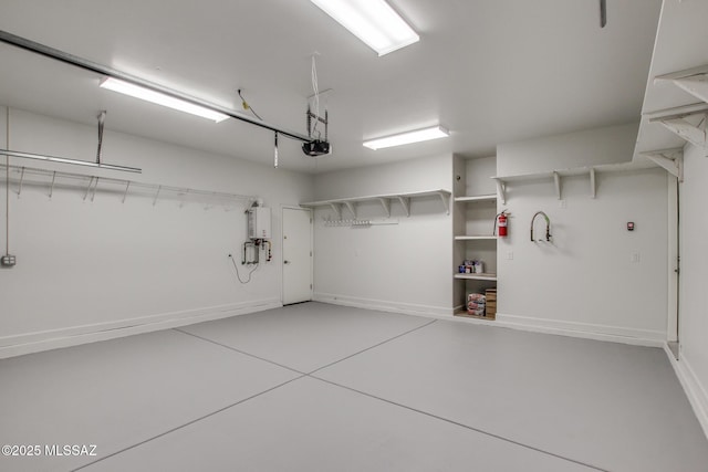9016 W Birchover Dr, Marana, AZ 85653 - garage with water heater, baseboards, and a garage door opener