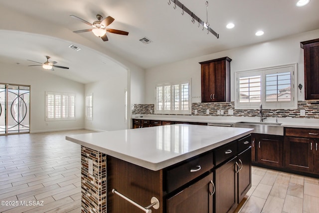 9016 W Birchover Dr, Marana, AZ 85653 - kitchen with a sink, ceiling fan, lofted ceiling, decorative backsplash, and open floor plan
