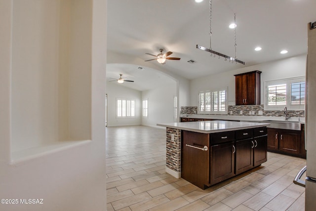 9016 W Birchover Dr, Marana, AZ 85653 - kitchen with decorative backsplash, light countertops, plenty of natural light, ceiling fan, and vaulted ceiling