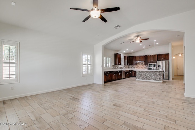 9016 W Birchover Dr, Marana, AZ 85653 - unfurnished living room featuring lofted ceiling, a ceiling fan, plenty of natural light, baseboards, and recessed lighting
