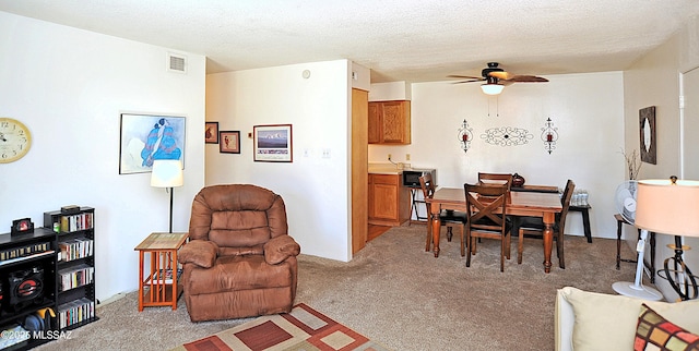441 W Yucca Ct Unit 209, Tucson, AZ 85704 - dining area featuring light carpet, a ceiling fan, and a textured ceiling