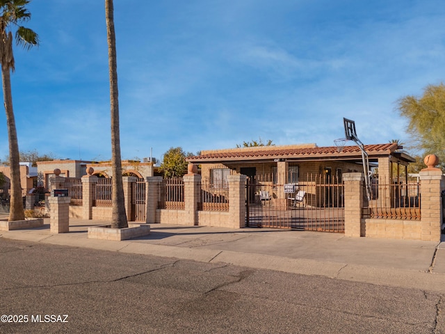 1410 W Sonora St, Tucson, AZ 85745 - view of front facade with a fenced front yard, a gate, and a tile roof