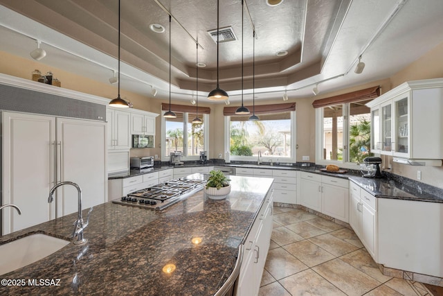 4141 W Camino Del Norte, Tucson, AZ 85742 - kitchen with a tray ceiling, paneled refrigerator, stainless steel gas cooktop, white cabinets, and a sink