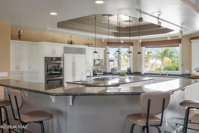 4141 W Camino Del Norte, Tucson, AZ 85742 - kitchen with stainless steel appliances, a breakfast bar, white cabinetry, and recessed lighting