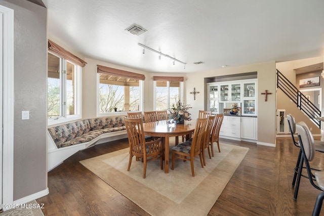 4141 W Camino Del Norte, Tucson, AZ 85742 - dining space with track lighting, dark wood finished floors, baseboards, and stairway