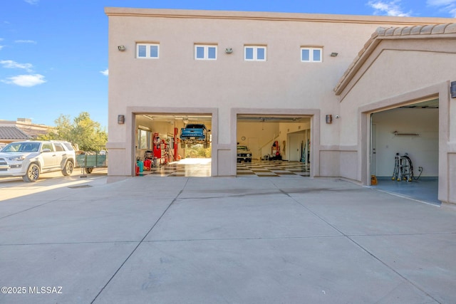 4141 W Camino Del Norte, Tucson, AZ 85742 - rear view of property with stucco siding and concrete driveway