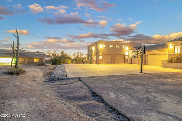 4141 W Camino Del Norte, Tucson, AZ 85742 - view of front of house featuring concrete driveway, stucco siding, a chimney, and a garage