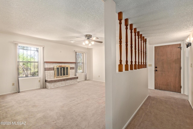 555 E Rudasill Rd, Tucson, AZ 85704 - unfurnished living room with a textured ceiling, carpet floors, ceiling fan, a fireplace, and baseboards