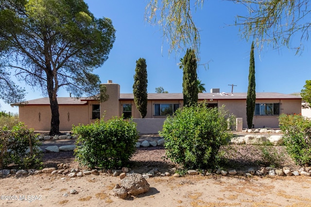 555 E Rudasill Rd, Tucson, AZ 85704 - rear view of house with stucco siding and a chimney