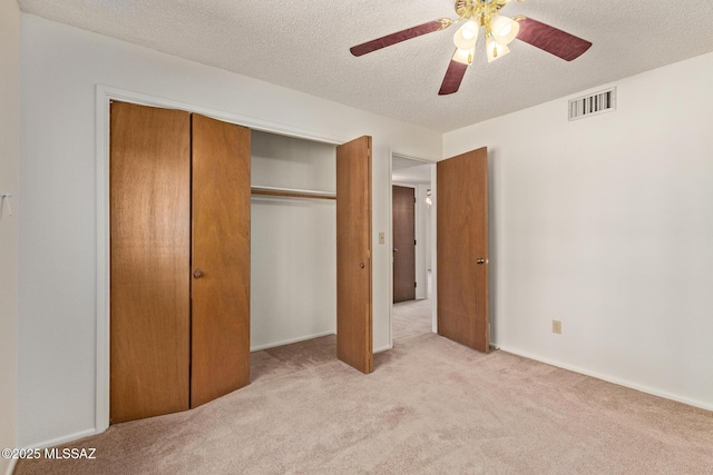 555 E Rudasill Rd, Tucson, AZ 85704 - unfurnished bedroom with light carpet, a textured ceiling, a closet, and ceiling fan