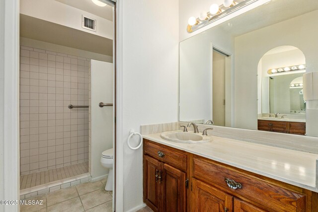 555 E Rudasill Rd, Tucson, AZ 85704 - bathroom featuring vanity, tile patterned floors, toilet, and tiled shower