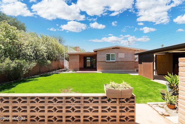 3225 E Elida St, Tucson, AZ 85716 - back of house featuring brick siding and stairway
