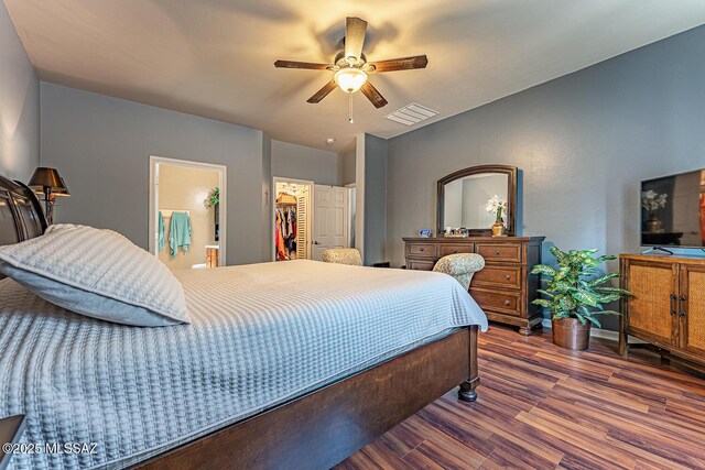 493 W Corte Planga, Sahuarita, AZ 85629 - bedroom featuring wood finished floors, a spacious closet, a ceiling fan, and baseboards