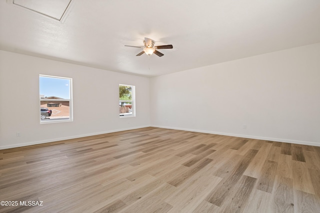 7112 S Haskins Dr, Tucson, AZ 85746 - spare room featuring a ceiling fan, light wood-style flooring, attic access, and baseboards