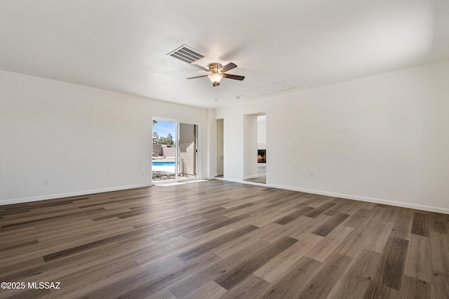 7112 S Haskins Dr, Tucson, AZ 85746 - spare room featuring attic access, ceiling fan, wood finished floors, and baseboards