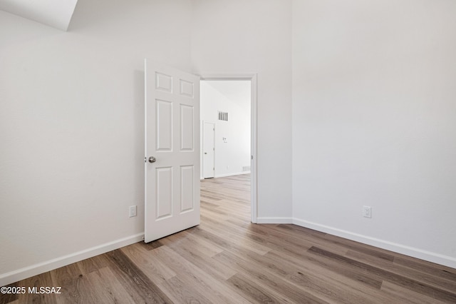 7112 S Haskins Dr, Tucson, AZ 85746 - spare room with light wood-style floors and baseboards