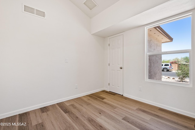 7112 S Haskins Dr, Tucson, AZ 85746 - unfurnished room featuring wood finished floors, baseboards, and vaulted ceiling