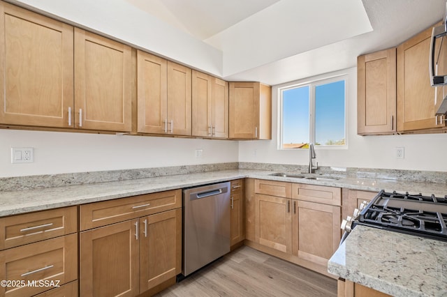 7112 S Haskins Dr, Tucson, AZ 85746 - kitchen with stainless steel appliances, a sink, light wood-type flooring, and light brown cabinetry