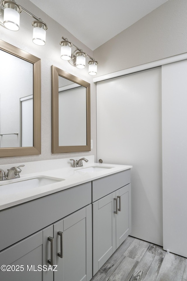 1542 N Amberbrooke Ave, Tucson, AZ 85745 - bathroom with double vanity and wood finished floors