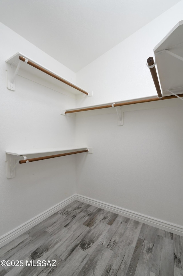 1542 N Amberbrooke Ave, Tucson, AZ 85745 - walk in closet featuring wood finished floors