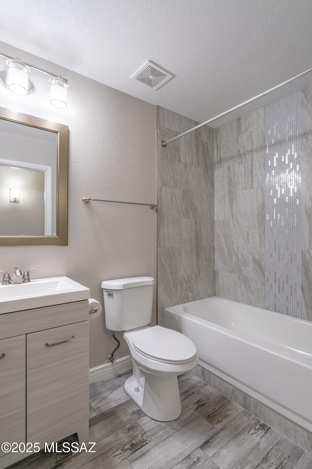 1542 N Amberbrooke Ave, Tucson, AZ 85745 - full bath with toilet, vanity,  shower combination, a textured ceiling, and wood finished floors